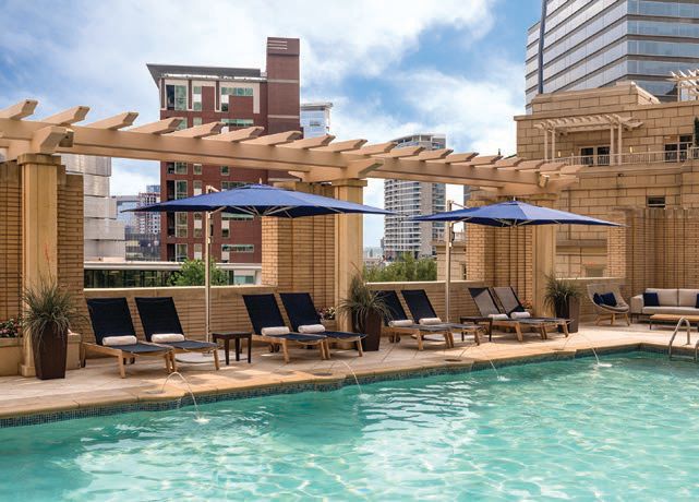 Lush amenities at the hotel’s outdoor pool. PHOTO COURTESY OF THE RITZ-CARLTON, DALLAS