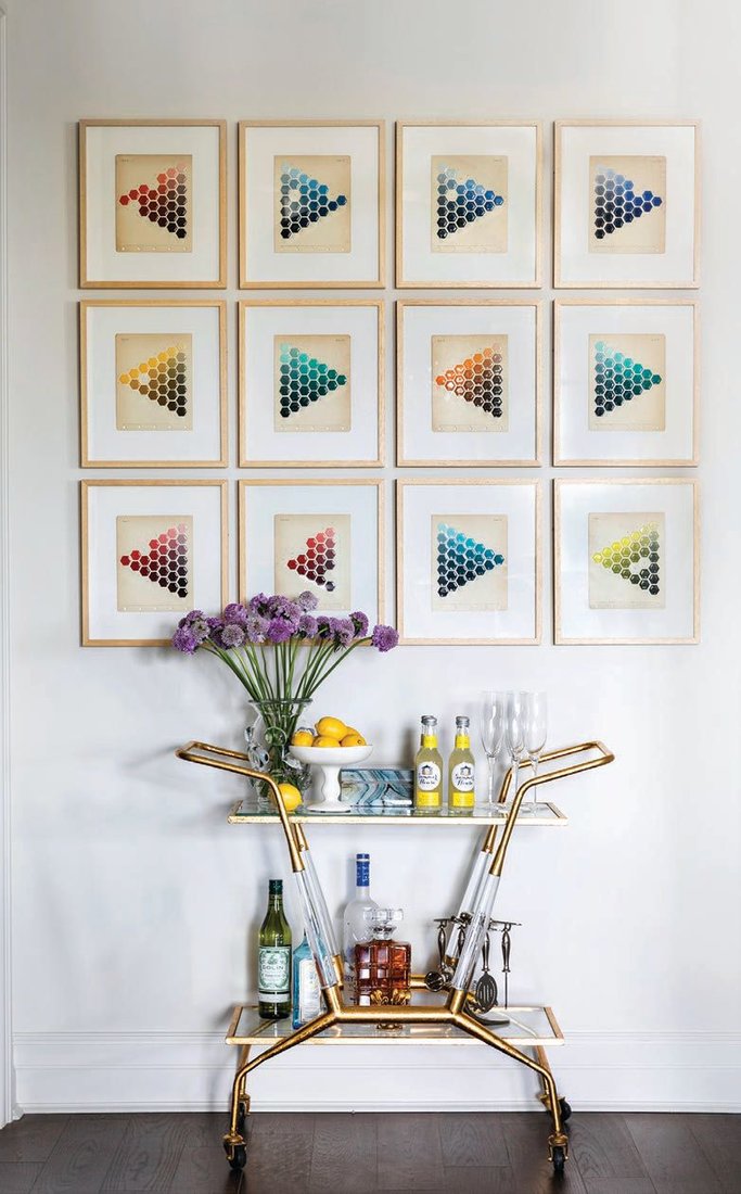 The bar cart nook located in the kitchen features colorful art from FOUND (foundforthehome.com) PHOTO BY JULIE SOEFER