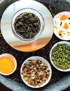 In addition to golden Kaluga, the caviar set includes spiced egg yolk, crumbled pistachios, cauliflower creme and rose labneh. PHOTO BY JULIE SOEFER